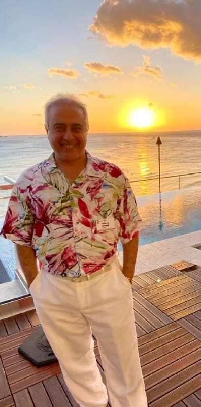 M. Shaker, Founder standing on a boat deck during sunset